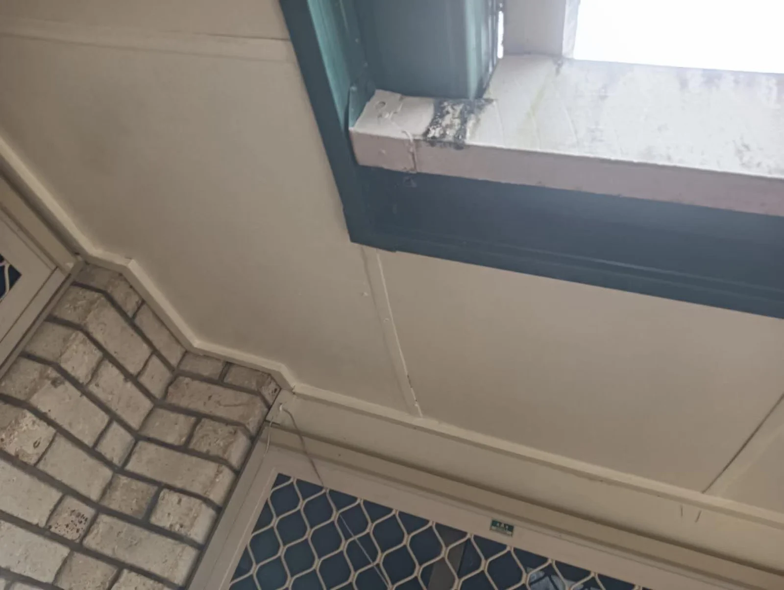 The repaired section of eaves lining after finishing and repainting